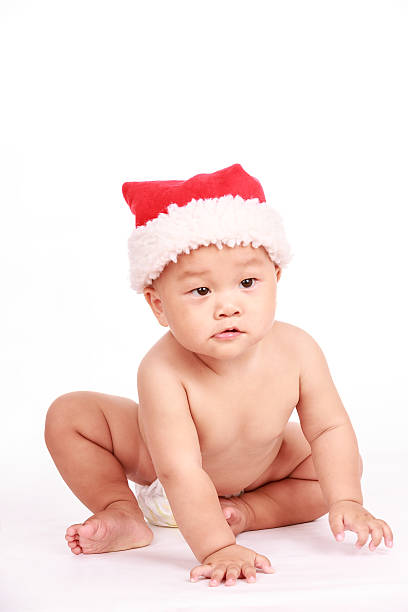 istock cute Asian baby boy wearing christmas cap 518675946