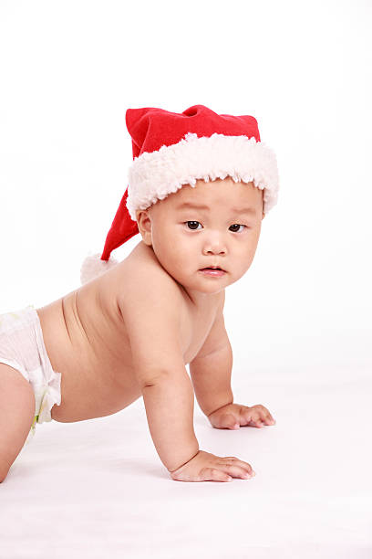 istock cute Asian baby boy wearing christmas cap 518675998