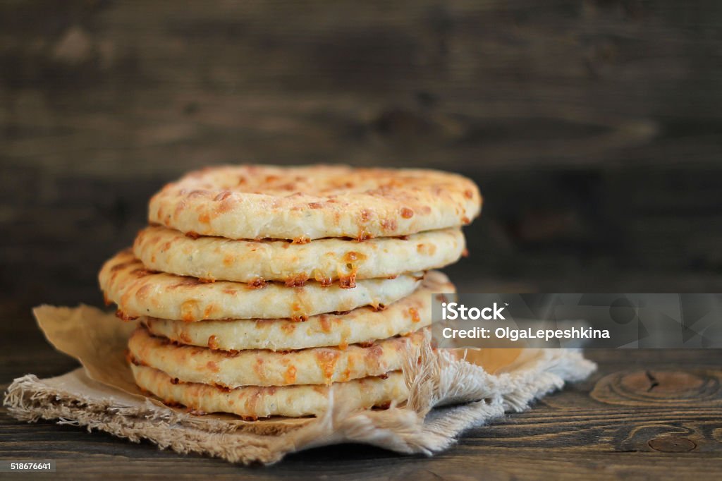 Cheese flat bread Traditional finnish cheese flat bread on a wooden background Baked Stock Photo