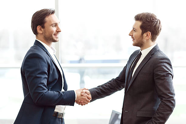 istock Positive business partners shaking hands 518676674