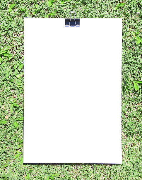 istock White sheet of paper lying on the grass 518677332