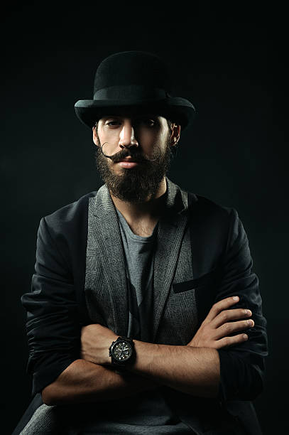 istock The bearded man in hat folded arms across his chest 518679123