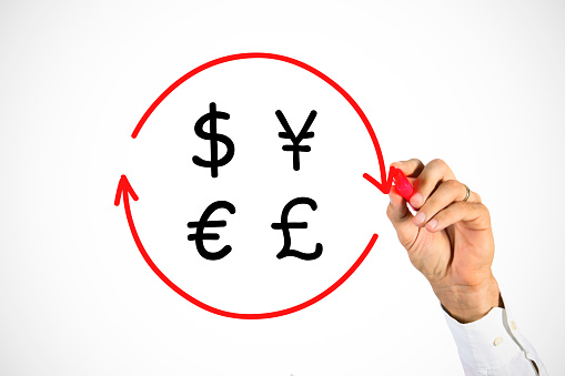 Male hand drawing dollar, pound and euro currency sign in arrow circle on transparent whiteboard (money exchange, refund or cash back concept). Unrecognizable Caucasian businessman.