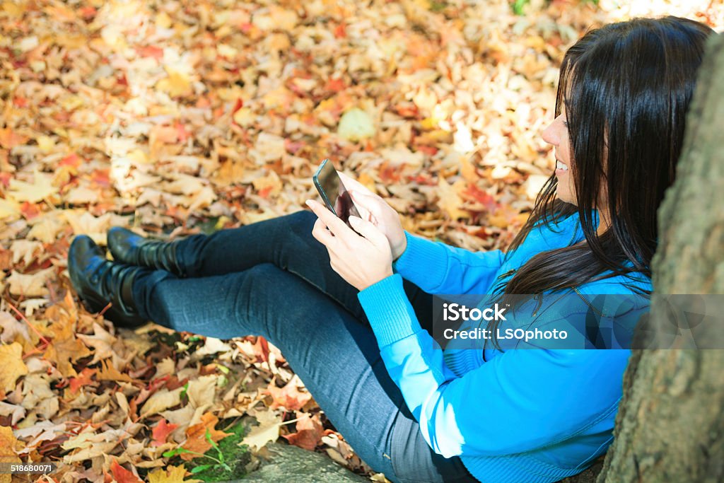 Autumne woman cellphone Park sit Autumne woman cellphone Park Adult Stock Photo