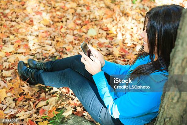Autumne Woman Cellphone Park Sit Stock Photo - Download Image Now - Adult, Horizontal, Mobile Phone