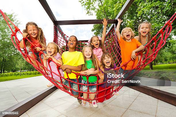 Group Of Kids Sitting On Playground Net Ropes Stock Photo - Download Image Now - 6-7 Years, African Ethnicity, Blond Hair