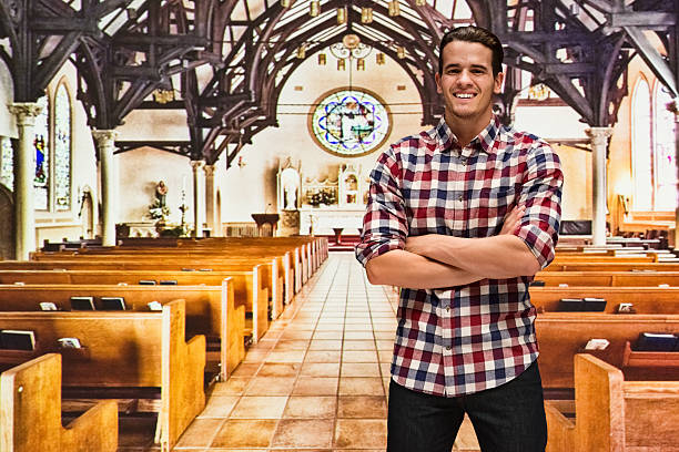 istock Smiling man standing in church 518680580
