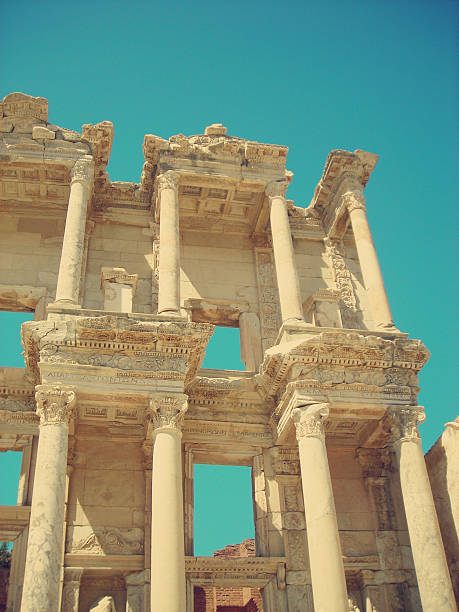 Ephesus archaeological site in summer, old library remains; retro style Archaeological remains of the old library at Ephesus, Anatolia, Turkey, on a sunny day. Image filtered in faded, retro, Instagram style with soft focus; nostalgic vintage travel concept. Izmir stock pictures, royalty-free photos & images