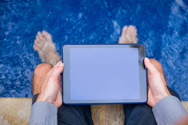 istock Adult male holding digital tablet with blank screen 518682252