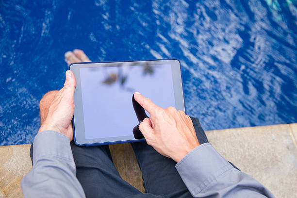 istock Adult men pointing on the digital tablet screen 518683400