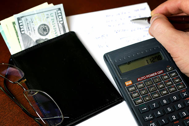 istock calculator on the table glasses money 518683416