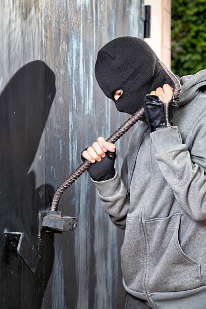 istock Burglar breaks lock on door 518684878