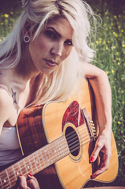 istock Girl musician playing the guitar 518687764