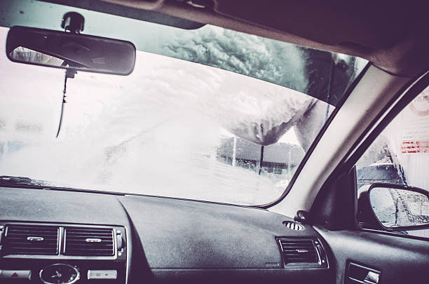 istock Man silhouette, car wash with water pressure and soap bubbles 518688902