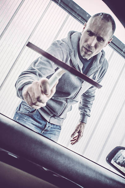 istock Man washing his car - drying windows 518688964