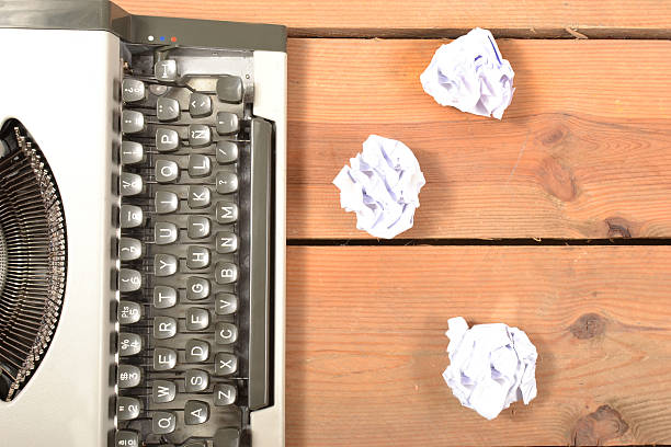 istock Typewriter and balls of paper 518697383