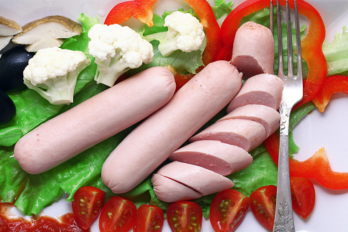 boiled sausages serving with vegetables