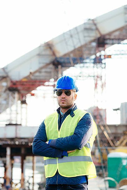 istock Engineer posing with arms crossed near the bridge 518698526