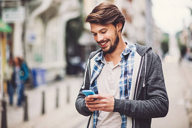 istock Smiling young man with a phone 518699190