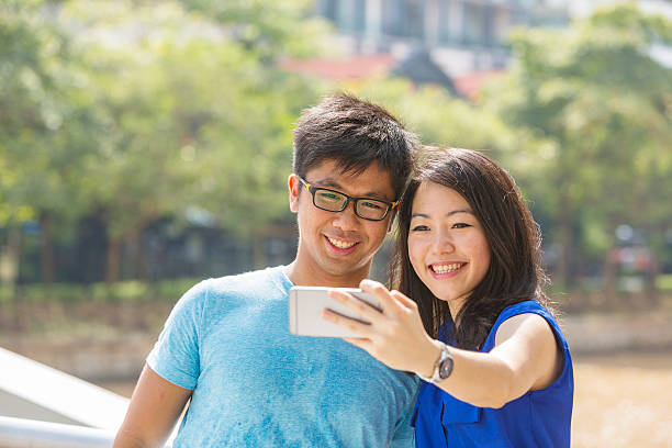 istock Romantic Young Couple Taking a Selfie in Singapore 518699394