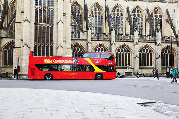 Oxford, United Kingdom - June 17, 2014:  Red open topped Oxford tour bus carrying passengers travelling along St Aldates, Oxford, Oxfordshire, England, UK, Western Europe.