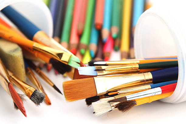 istock Art supplies including paint brushes and colored pencils 518700041