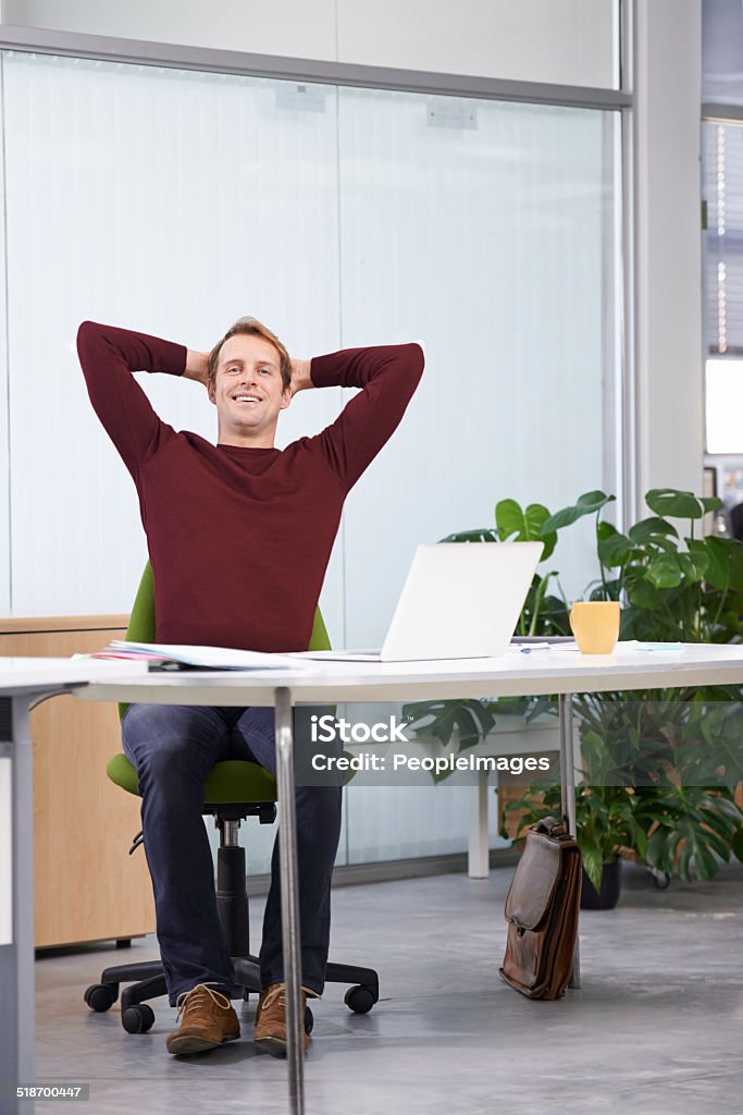 That feeling you get when you beat a deadline A handsome businessman working at his desk Men Stock Photo
