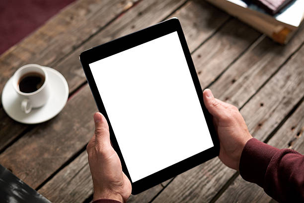 istock Man shows screen of tablet in his hands 518702696