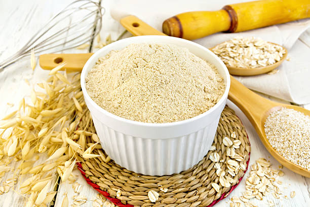 istock Flour oat in white bowl on light board 518703808