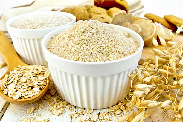istock Flour oat in white bowl with flakes in spoon 518704052