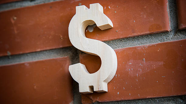 istock Wooden dollar symbol on brick wall background 518705288