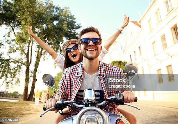 Portrait Of Happy Young Couple On Scooter Enjoying Road Trip Stock Photo - Download Image Now