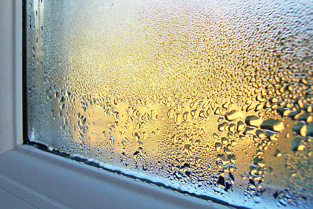 Condensation on Window Glass and Frame Windowsill and glass covered in condensation water droplets condensation stock pictures, royalty-free photos & images