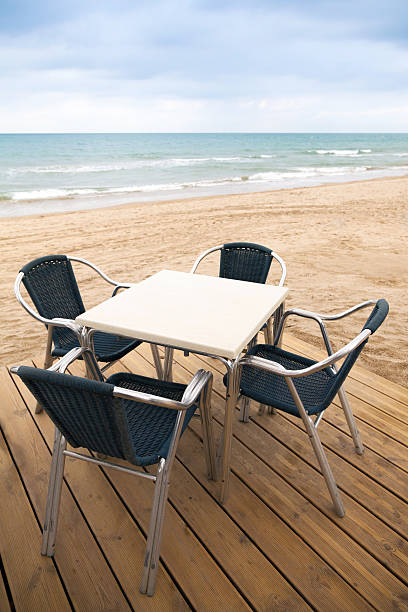 istock Sea side bar interior with wooden floor and armchairs 518717541