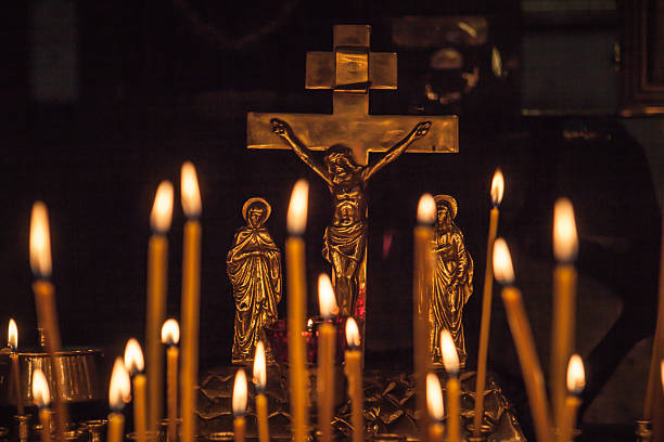 istock Icon lamp with Jesus on cross and burning candles 518719531