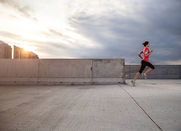 istock Young woman running at urban place 518720855