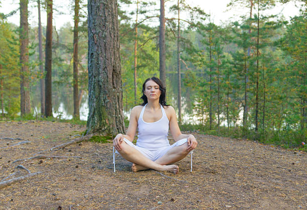 istock Woman meditate in the forest 518720871