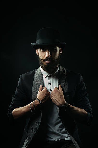 istock The bearded man in a bowler hat holding his lapels 518721047