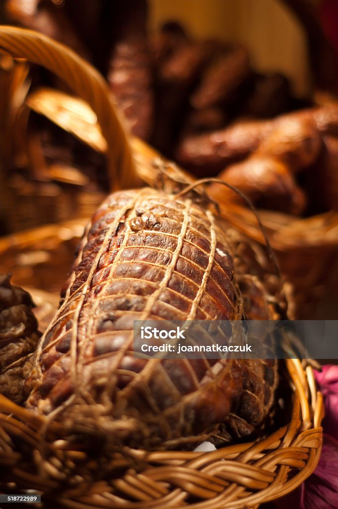 Smoked ham Fresh smoked ham in wicker basket. Traditional polish country pork meat. Perfect for sandwich. Other meats in background. Animal Stock Photo