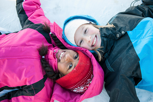 Little girls enjoying the outdoors in the winter time.