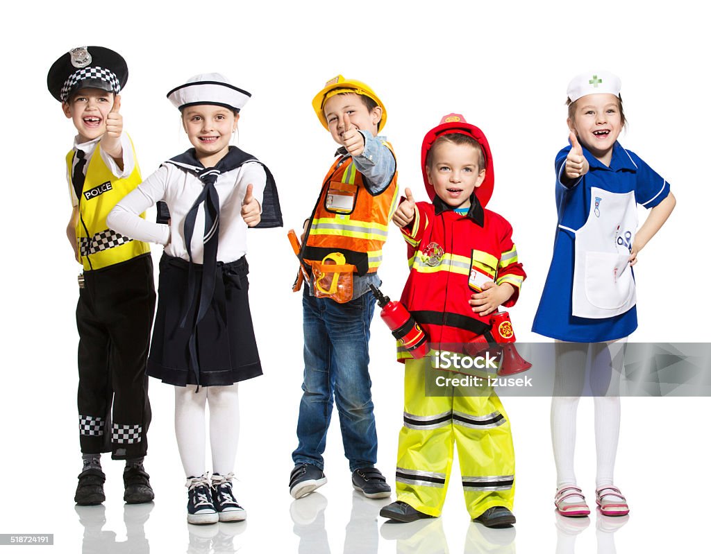 Kids and Professions Five excited kids standing with thumbs up, each one with a unique profession: policeman, sailor, firefighter, nurse and builder. Studio shot, isolated on white. Child Stock Photo