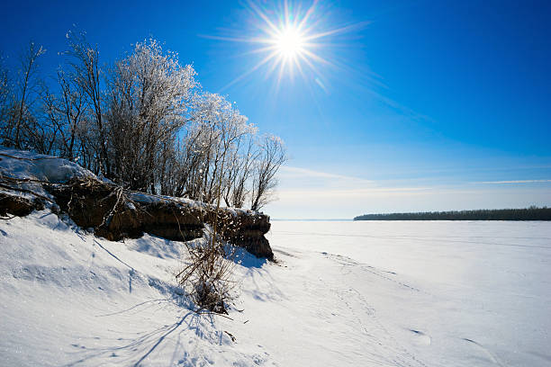 istock The sun over trees on hill by river in winter. 518727748