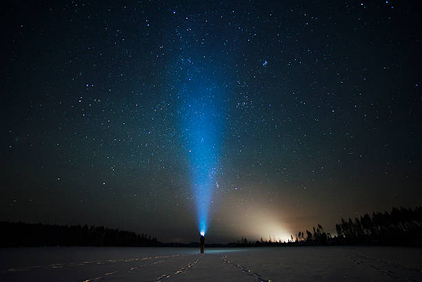 istock blue ray of flashlight in the starry sky 518727864