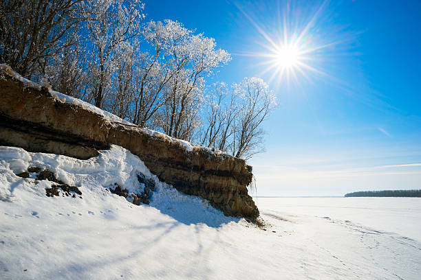 istock The sun over trees on hill by river in winter. 518727884
