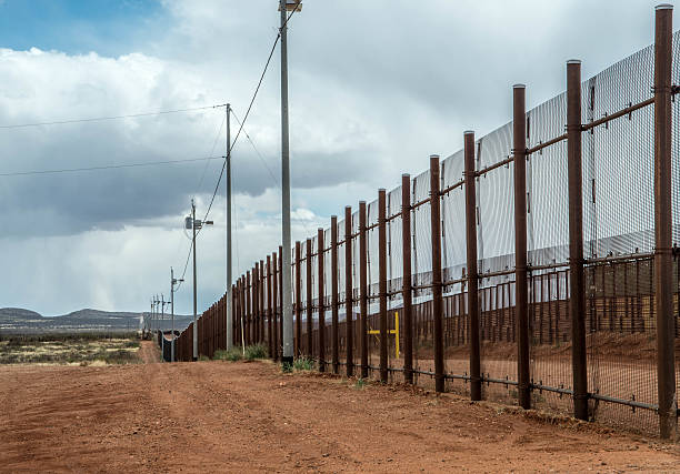 Border fence at Naco Arizona Fence at Mexico United States border in Naco Arizona international border barrier stock pictures, royalty-free photos & images
