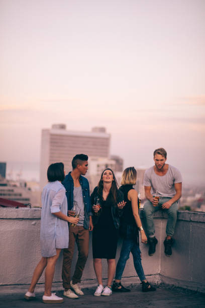 istock Hipster style friends celebrating a summer rooftop party 518728410