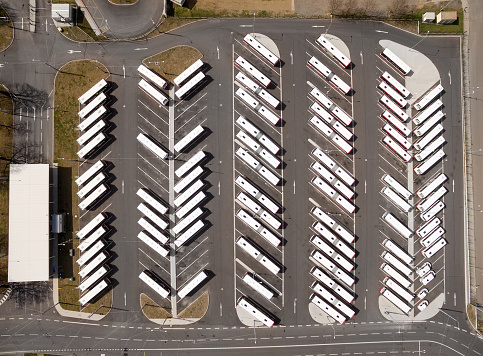 Aerial view to parking lot for autobus and trucks. Industrial background on transportation theme.