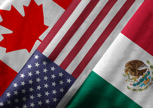 Closeup of the flags of the North American Free Trade Agreement NAFTA members on textile texture. NAFTA is the world's largest trade bloc and the member countries are Canada, United States and Mexico. 3D rendering with detailed textured grunge effect on closeup.