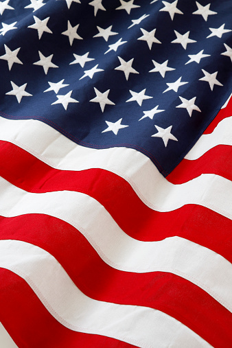 USA flag on textured wall background - American patriotism symbol