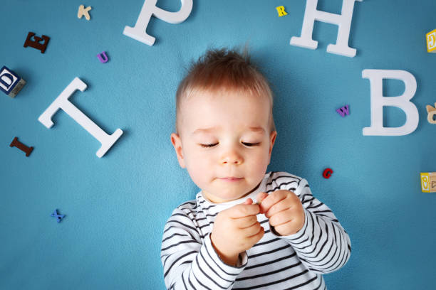 istock One year old child lying with spectacles and letters 518730012